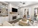 Bright living room boasts stone fireplace, built-in shelving, and access to a balcony at 4358 Parkside Pl, Atlanta, GA 30342
