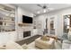 Bright living room boasts stone fireplace, built-in shelving, and access to a balcony at 4358 Parkside Pl, Atlanta, GA 30342