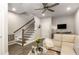 Inviting living room featuring a plush sofa, stairs with a dark railing, and a decorative animal print rug at 4358 Parkside Pl, Atlanta, GA 30342