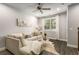 Comfortable living room with a plush sofa, a stylish table, a window with curtains, and a decorative floral art piece at 4358 Parkside Pl, Atlanta, GA 30342