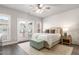 Bedroom with whitewashed brick wall, plush bed, and access to outdoor balcony at 4358 Parkside Pl, Atlanta, GA 30342