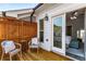 Relaxing outdoor patio with wooden floors, comfortable seating, and a view into the serene bedroom through sliding glass doors at 4358 Parkside Pl, Atlanta, GA 30342