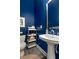 Chic powder room featuring dark blue walls, pedestal sink, and modern fixtures at 4358 Parkside Pl, Atlanta, GA 30342