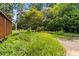 Beautiful backyard featuring lush landscaping, a rustic shed, and mature trees at 2628 Tanglewood Rd, Decatur, GA 30033