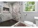 Elegant bathroom featuring marble shower, sleek fixtures, and a window bringing in natural light at 2628 Tanglewood Rd, Decatur, GA 30033