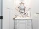 Chic bathroom featuring a marble accent wall, a decorative mirror, and a sleek, white vanity at 2628 Tanglewood Rd, Decatur, GA 30033