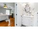 Bathroom with marble look wall, mirror, and white vanity at 2628 Tanglewood Rd, Decatur, GA 30033
