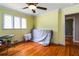 Sunlit bedroom with hardwood flooring, a ceiling fan, and a window for natural light at 2628 Tanglewood Rd, Decatur, GA 30033