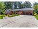 Charming brick ranch-style home with a spacious driveway, covered parking, and beautiful landscaping at 2628 Tanglewood Rd, Decatur, GA 30033