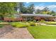 Beautiful home exterior with lush landscaping, inviting entrance, and attached covered parking at 2628 Tanglewood Rd, Decatur, GA 30033