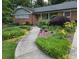 Charming brick home with well-manicured landscaping, walkway, and American flag at 2628 Tanglewood Rd, Decatur, GA 30033