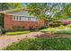 Charming exterior showing brick facade and manicured garden, presenting a classic curb appeal at 2628 Tanglewood Rd, Decatur, GA 30033