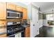 Well-equipped kitchen with stainless steel stove, built-in microwave, and a view to the dining area at 2628 Tanglewood Rd, Decatur, GA 30033