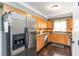 Well-lit kitchen boasts stainless steel refrigerator, ample counter space, and wooden cabinets at 2628 Tanglewood Rd, Decatur, GA 30033