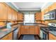 Kitchen boasts stainless steel appliances, stone backsplash, and spacious countertops at 2628 Tanglewood Rd, Decatur, GA 30033