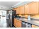 Bright kitchen features stainless steel appliances, light wood cabinets, and tile backsplash at 2628 Tanglewood Rd, Decatur, GA 30033