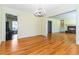 Open concept living room featuring hardwood floors, chandelier, and easy access to other rooms at 2628 Tanglewood Rd, Decatur, GA 30033