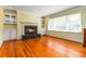 Bright living room features a marble fireplace, built-in cabinets, and hardwood floors at 2628 Tanglewood Rd, Decatur, GA 30033