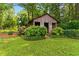 Charming outdoor shed surrounded by colorful flowers and greenery in the backyard at 2628 Tanglewood Rd, Decatur, GA 30033