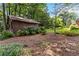 Backyard shed surrounded by flowers and mature trees at 2628 Tanglewood Rd, Decatur, GA 30033