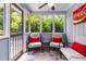 Charming sunroom features tile floors, comfortable seating, and lots of natural light at 2628 Tanglewood Rd, Decatur, GA 30033