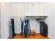 Functional walk-in closet features adjustable shelving, clothes racks, and hardwood floors at 2628 Tanglewood Rd, Decatur, GA 30033