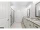 A well-lit bathroom featuring a double vanity with granite countertops, a glass-enclosed shower, and tile flooring at 113 Overlook Ridge Way Way, Canton, GA 30114