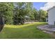 Well-maintained backyard featuring a deck and gazebo, bordered by lush trees at 129 Academy Ln, Canton, GA 30114