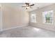 Bedroom with natural light, plush carpet, and ceiling fan at 129 Academy Ln, Canton, GA 30114