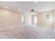 Large bedroom with neutral walls, plush carpet, and a ceiling fan providing a soothing atmosphere at 129 Academy Ln, Canton, GA 30114