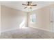 Bedroom with neutral walls, plush carpet, and ceiling fan at 129 Academy Ln, Canton, GA 30114