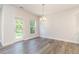Bright dining room with modern flooring, neutral walls, and a glass door at 129 Academy Ln, Canton, GA 30114