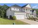Side view of a lovely home featuring a well-maintained lawn and a two-car garage at 129 Academy Ln, Canton, GA 30114
