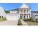 Charming two-story home featuring a welcoming front porch and a two-car garage at 129 Academy Ln, Canton, GA 30114