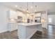 Modern kitchen featuring sleek white cabinetry, a large center island, and stainless steel appliances at 129 Academy Ln, Canton, GA 30114