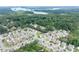 Charming neighborhood aerial view showcasing lush greenery and a beautiful lake in the background at 207 Cross Rd, Acworth, GA 30102