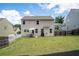 Large backyard with a patio, grass lawn, and tasteful landscaping at 207 Cross Rd, Acworth, GA 30102