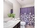 Cozy bathroom with lots of storage and a stand up shower with a purple curtain at 207 Cross Rd, Acworth, GA 30102