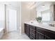 Bright bathroom boasts a double vanity with dark cabinets and a door to the toilet at 207 Cross Rd, Acworth, GA 30102