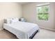 Bright bedroom with a full sized bed, small side chair, and large window at 207 Cross Rd, Acworth, GA 30102