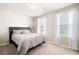 Cozy bedroom with neutral tones, natural light from the windows, and a comfortable bed at 207 Cross Rd, Acworth, GA 30102