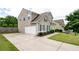 Exterior view of the home featuring a driveway and well-manicured landscaping at 207 Cross Rd, Acworth, GA 30102