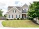 Charming two-story home featuring manicured lawn and stone-accented landscaping at 207 Cross Rd, Acworth, GA 30102