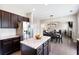 Open concept kitchen with stainless steel appliances, granite countertops, and a view of the dining and living area at 207 Cross Rd, Acworth, GA 30102