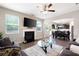 Spacious living room with fireplace, hardwood floors, and an open view to the kitchen and dining area at 207 Cross Rd, Acworth, GA 30102