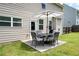 Cozy backyard patio featuring an umbrella-covered dining set and lush green lawn at 207 Cross Rd, Acworth, GA 30102