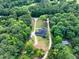 Panoramic aerial view of a secluded home surrounded by lush trees, with long driveways on a sprawling lot at 332 Mount Zion Rd, Oxford, GA 30054