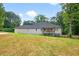 Spacious backyard view featuring a cozy deck and mature trees, perfect for outdoor relaxation at 332 Mount Zion Rd, Oxford, GA 30054