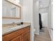 Well-lit bathroom boasts granite counters, wood-look flooring and a large mirror at 332 Mount Zion Rd, Oxford, GA 30054