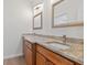 Bathroom featuring a double vanity with granite countertops and wooden cabinets at 332 Mount Zion Rd, Oxford, GA 30054